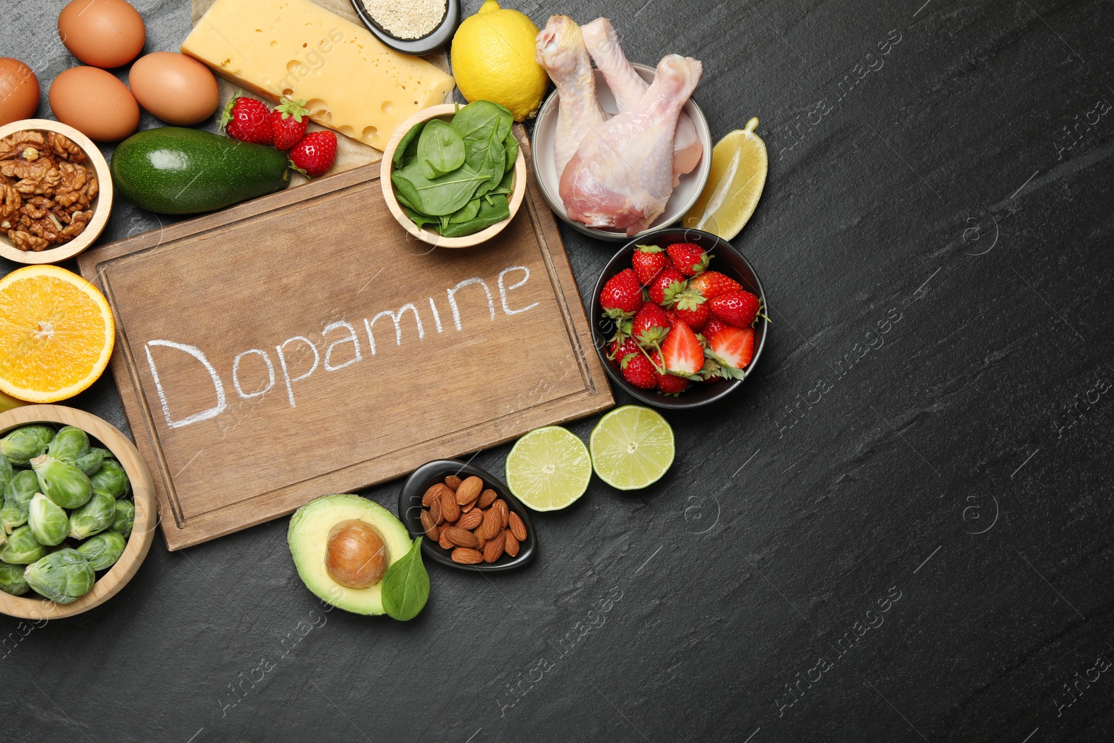 Photo of Wooden board with word Dopamine and different fresh products on grey textured table, flat lay. Space for text