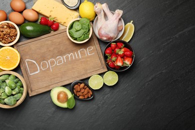 Photo of Wooden board with word Dopamine and different fresh products on grey textured table, flat lay. Space for text