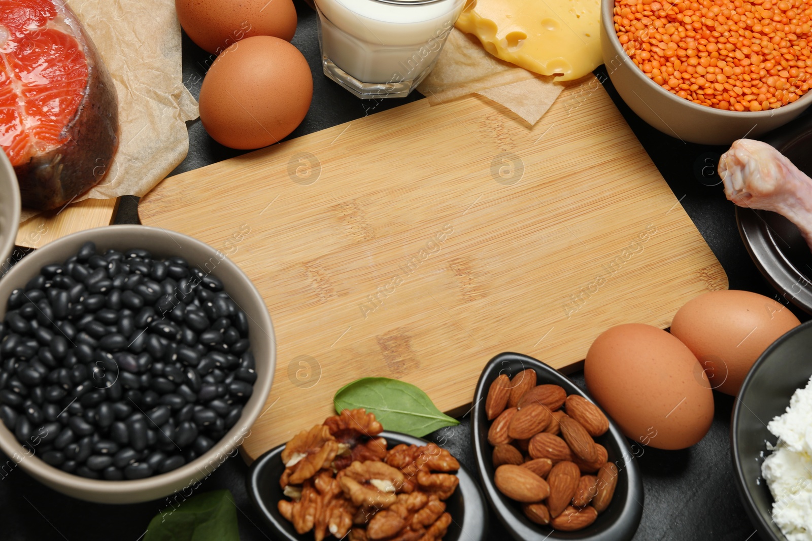 Photo of Different fresh products rich in estrogen and wooden board on grey table