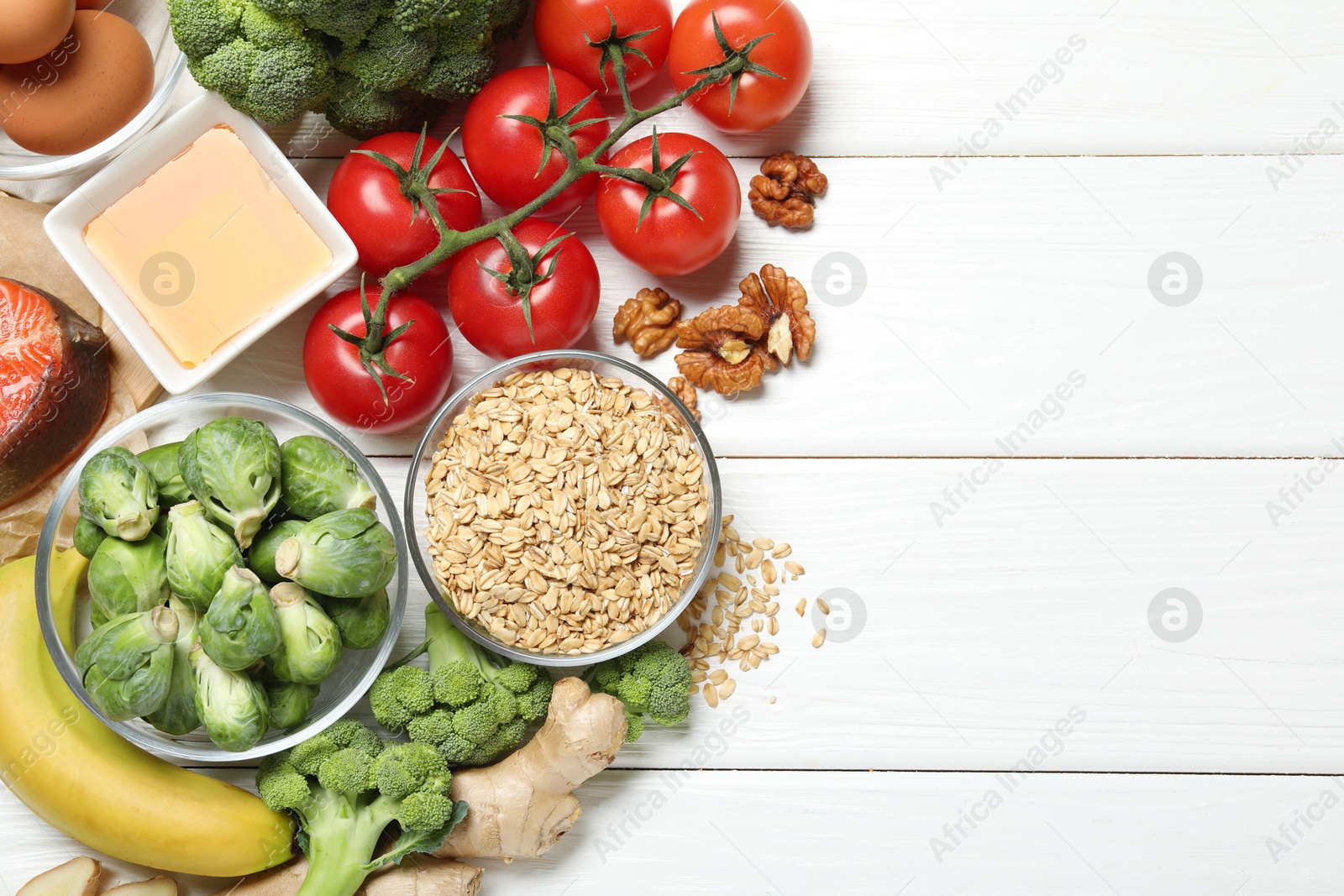 Photo of Different fresh products rich in melatonin on white wooden table, flat lay. Space for text