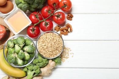 Photo of Different fresh products rich in melatonin on white wooden table, flat lay. Space for text