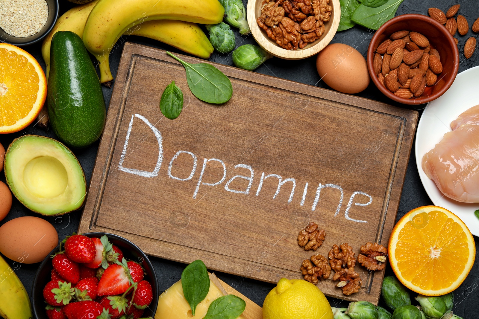 Photo of Wooden board with word Dopamine and different fresh products on grey table, flat lay