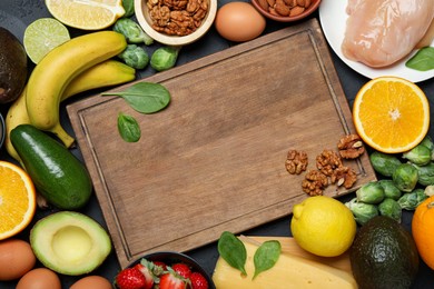 Photo of Wooden board with word Dopamine and different fresh products on grey table, flat lay