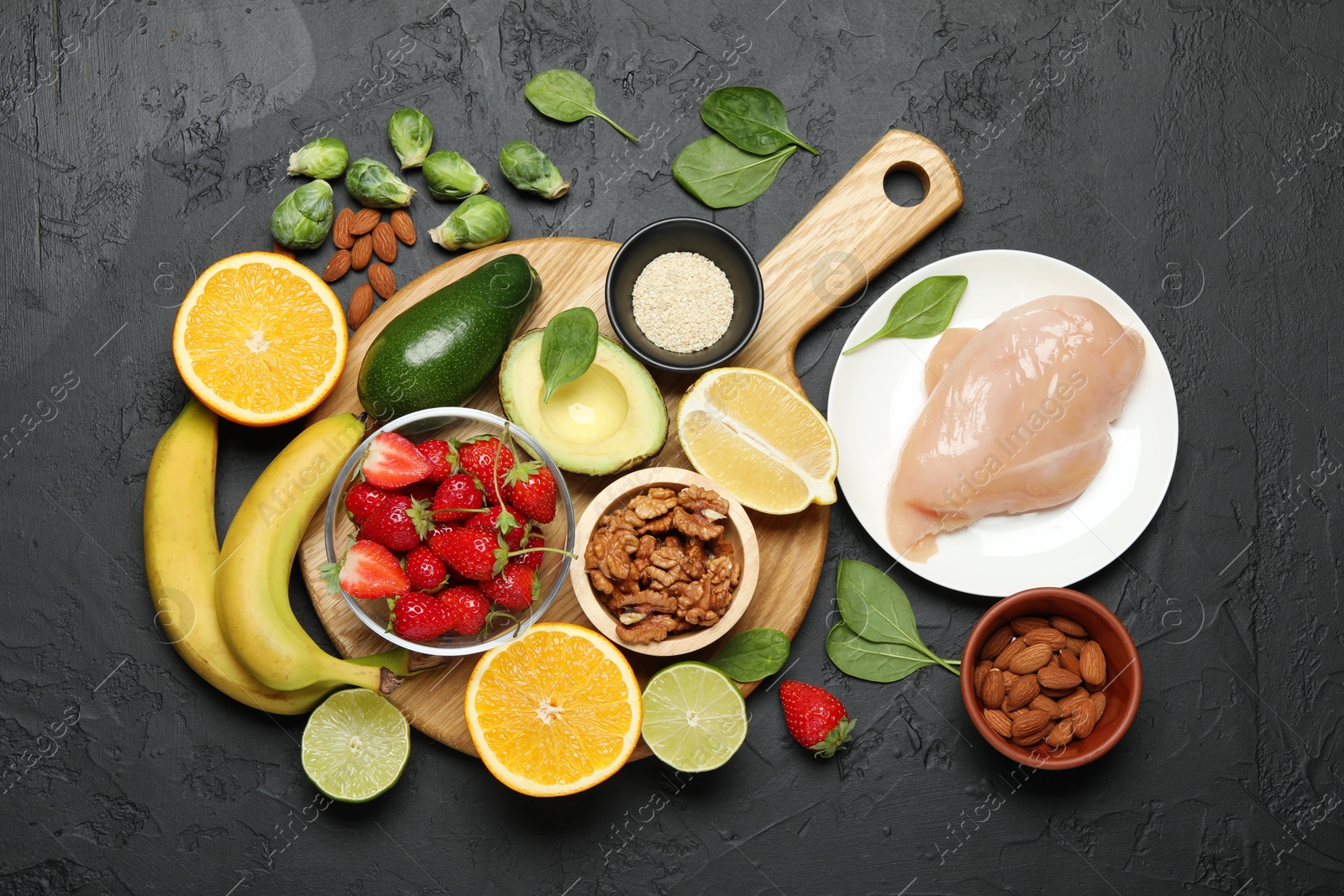 Photo of Different fresh products rich in dopamine on grey textured table, flat lay