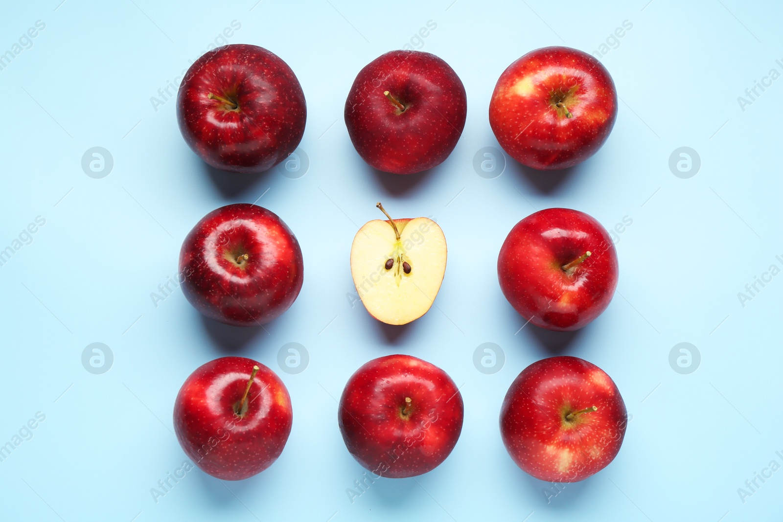 Photo of Fresh ripe red apples on light blue background, flat lay