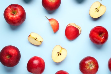 Photo of Fresh ripe red apples on light blue background, flat lay