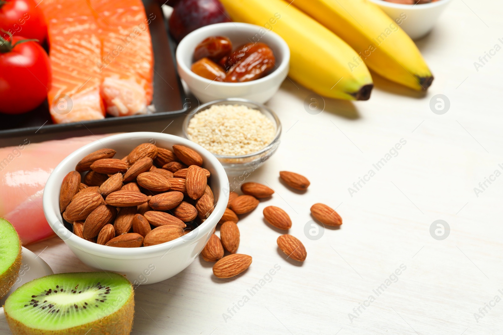 Photo of Different products rich in serotonin on white wooden table, closeup