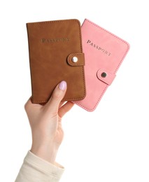 Photo of Woman holding passports in color covers on white background, closeup