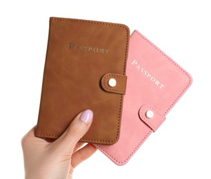 Photo of Woman holding passports in color covers on white background, closeup