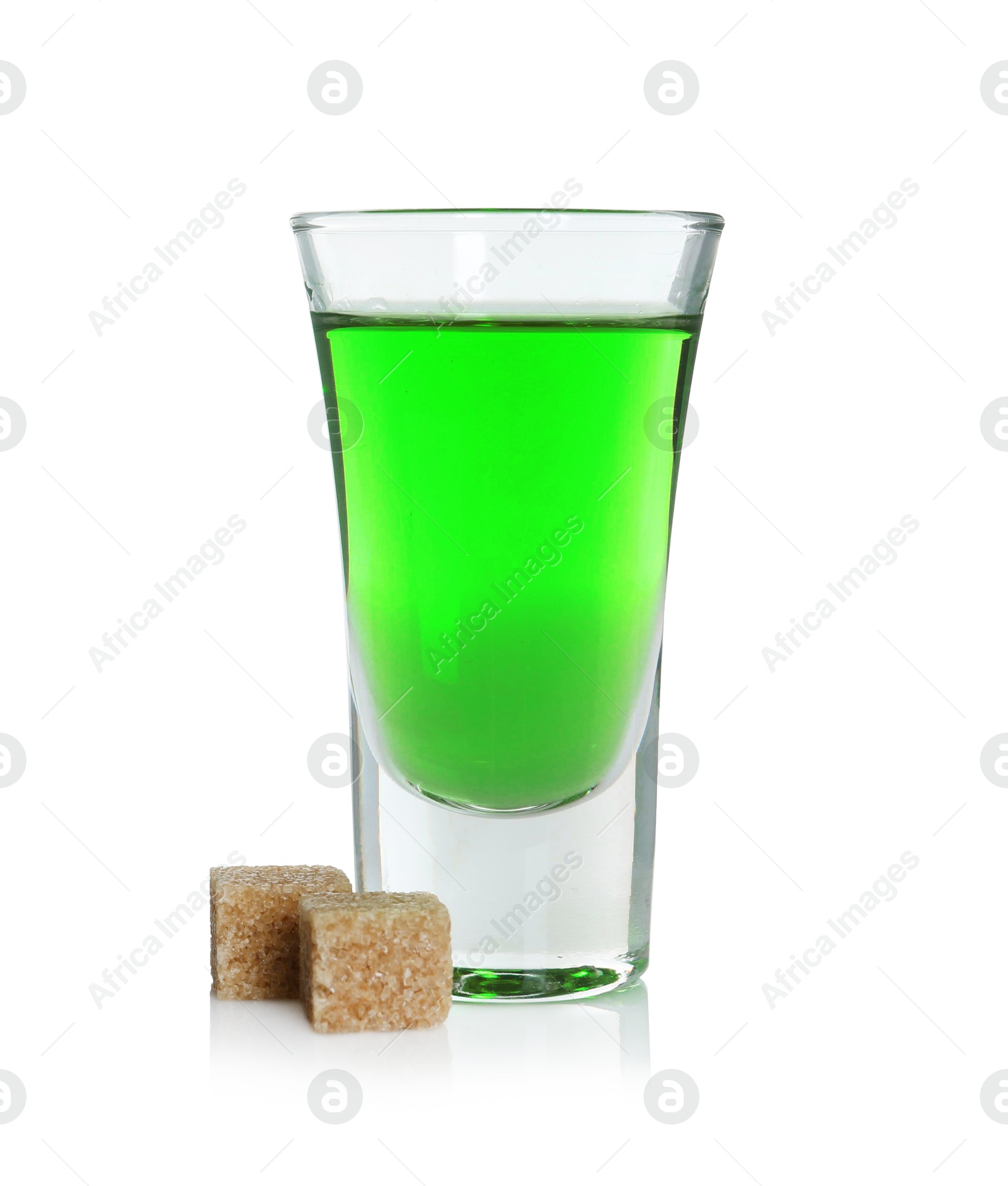 Photo of Absinthe in shot glass and brown sugar isolated on white