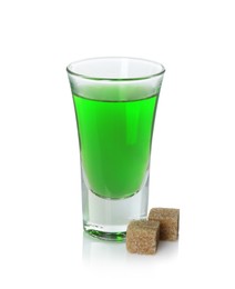 Photo of Absinthe in shot glass and brown sugar isolated on white