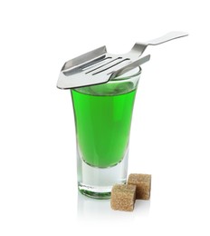 Photo of Absinthe in shot glass, brown sugar and slotted spoon isolated on white