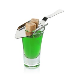 Photo of Absinthe in shot glass, brown sugar and slotted spoon isolated on white