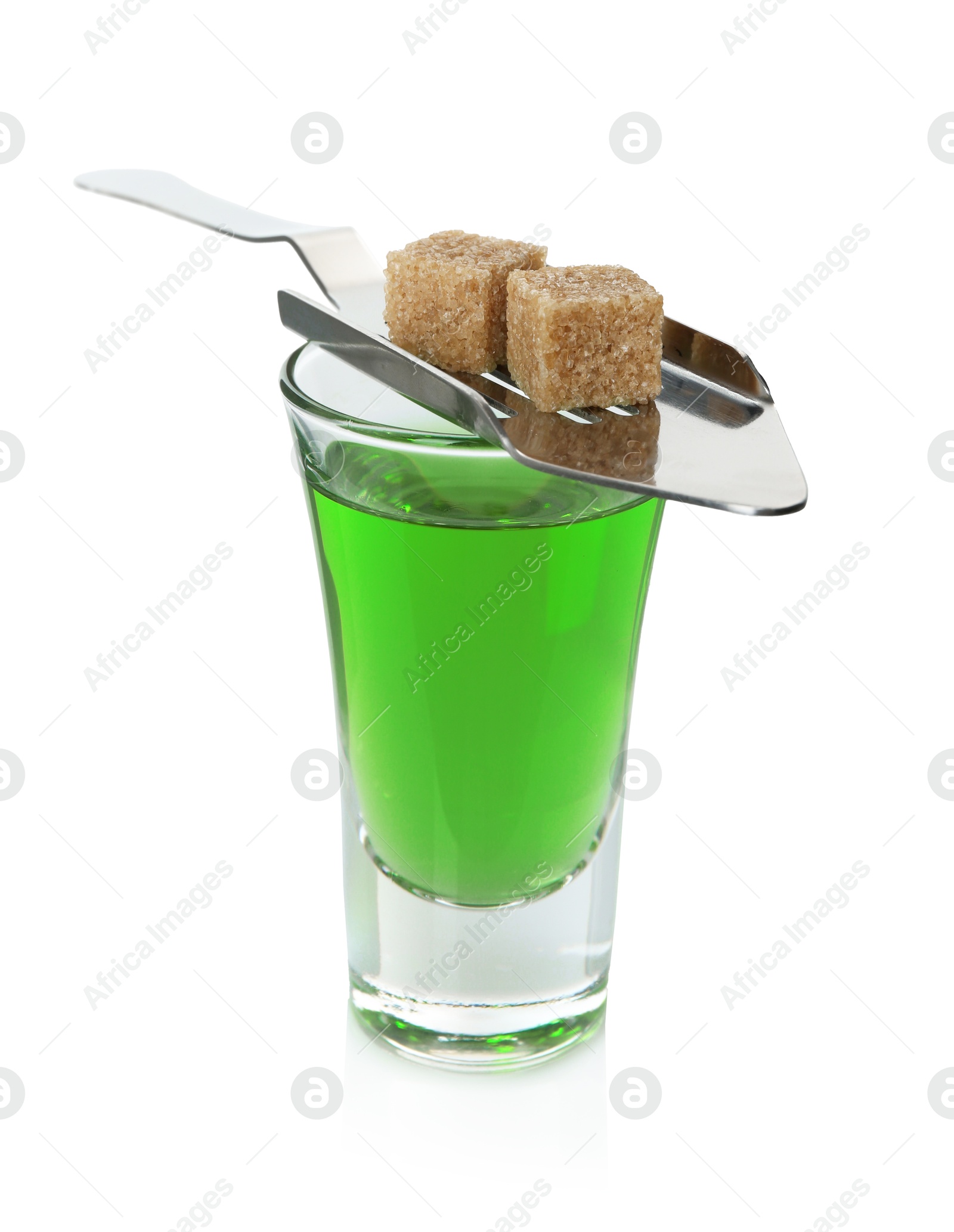 Photo of Absinthe in shot glass, brown sugar and slotted spoon isolated on white