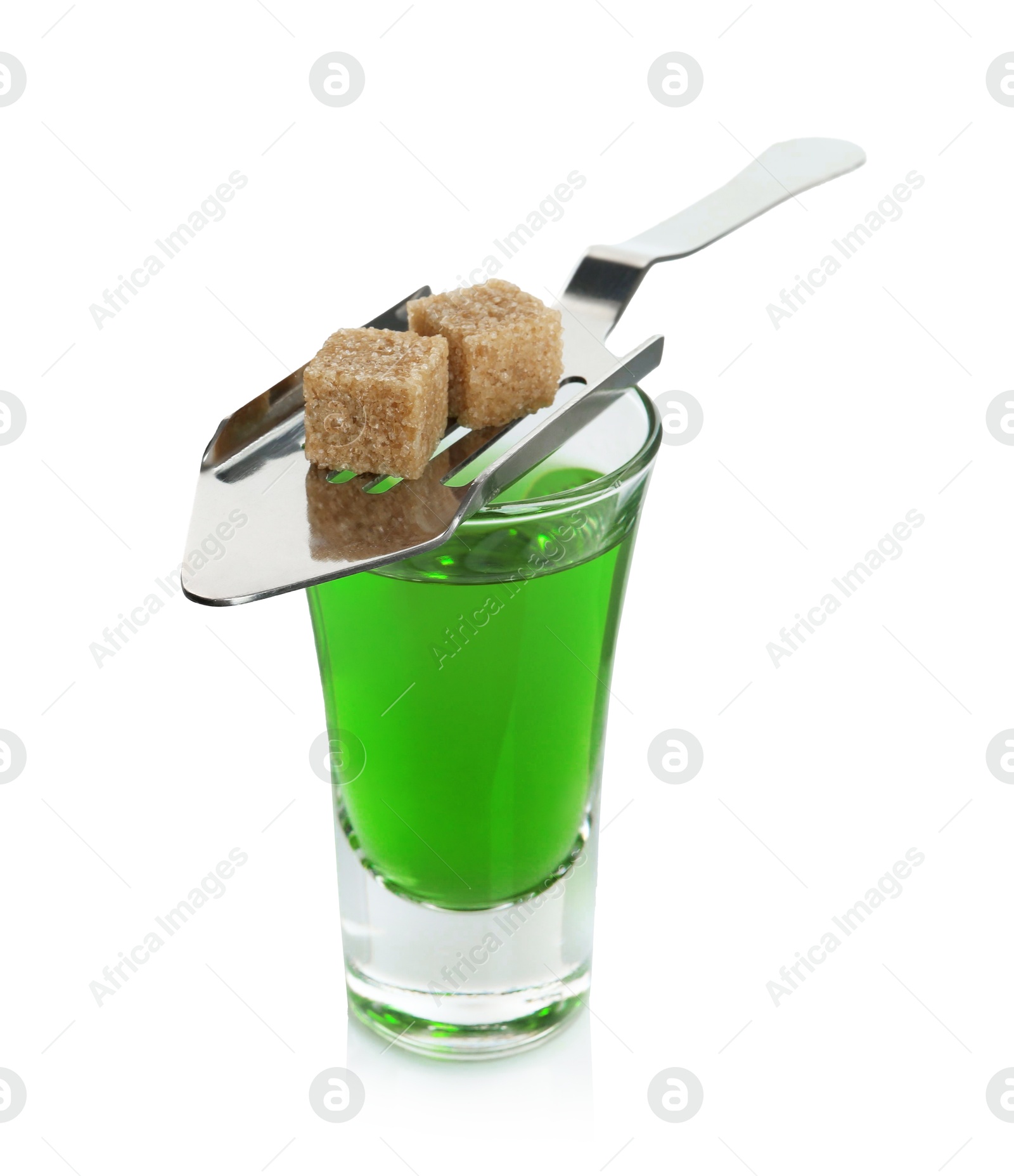 Photo of Absinthe in shot glass, brown sugar and slotted spoon isolated on white