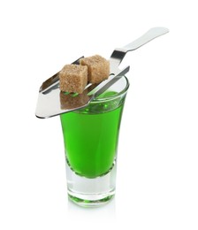 Photo of Absinthe in shot glass, brown sugar and slotted spoon isolated on white