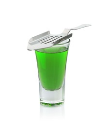 Photo of Absinthe in shot glass and slotted spoon isolated on white