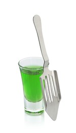 Photo of Absinthe in shot glass and slotted spoon isolated on white