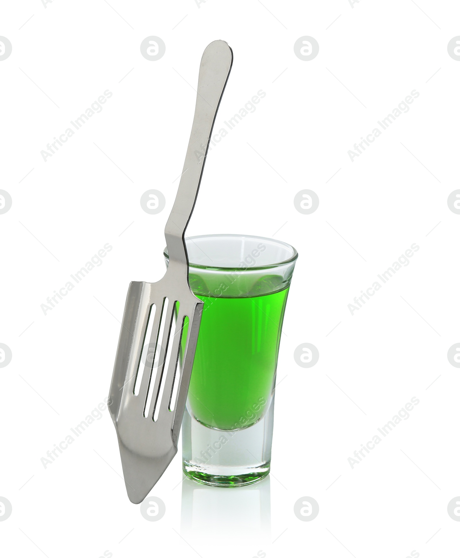 Photo of Absinthe in shot glass and slotted spoon isolated on white