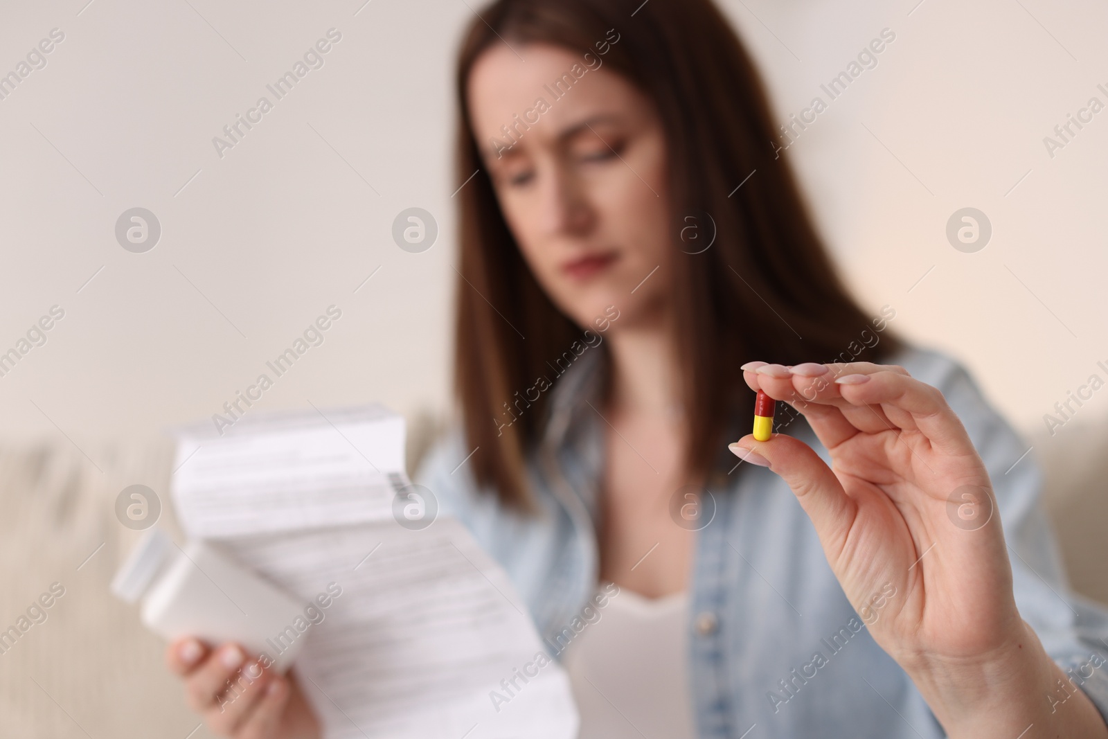 Photo of Woman with pill and instruction, selective focus