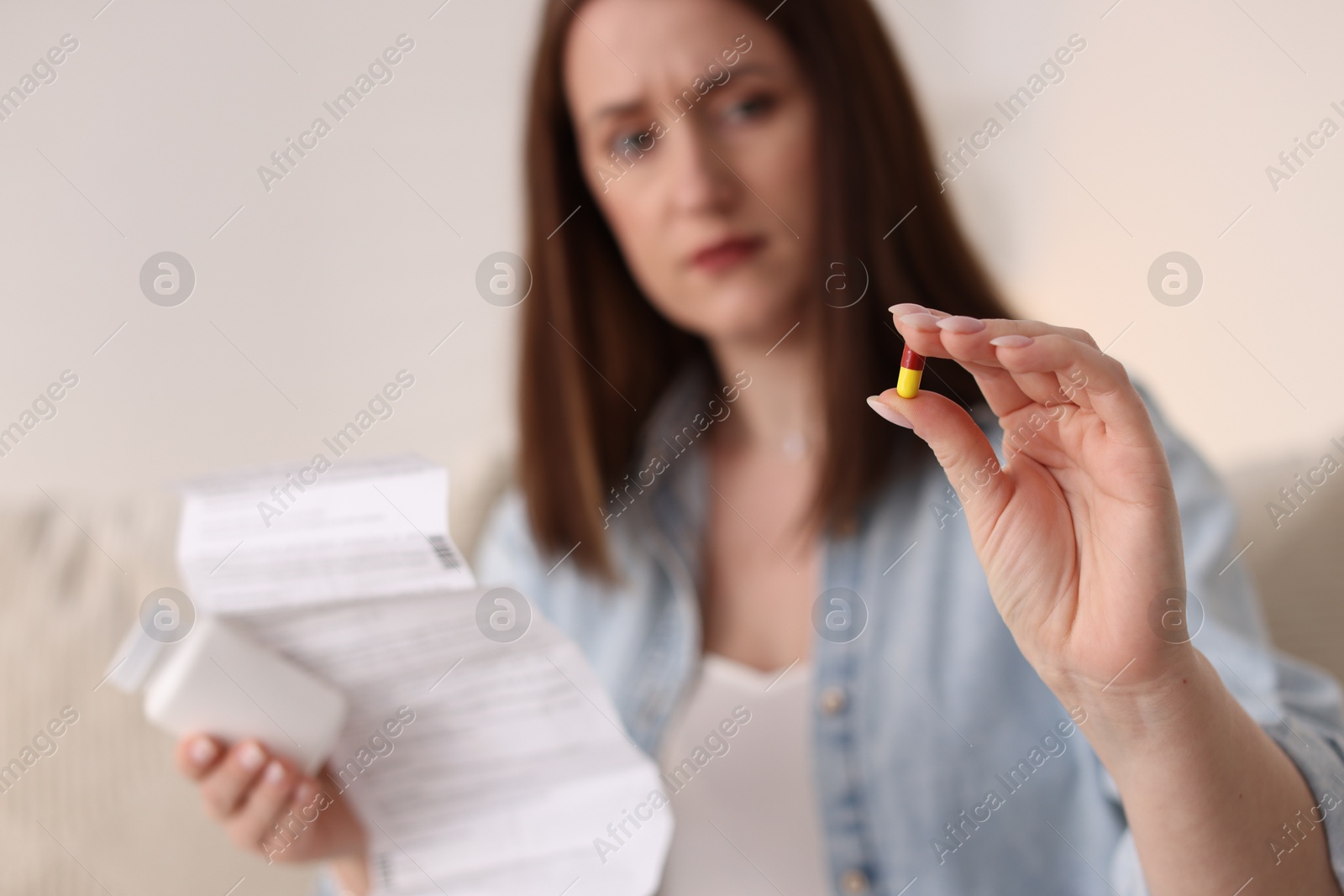 Photo of Woman with pill and instruction, selective focus