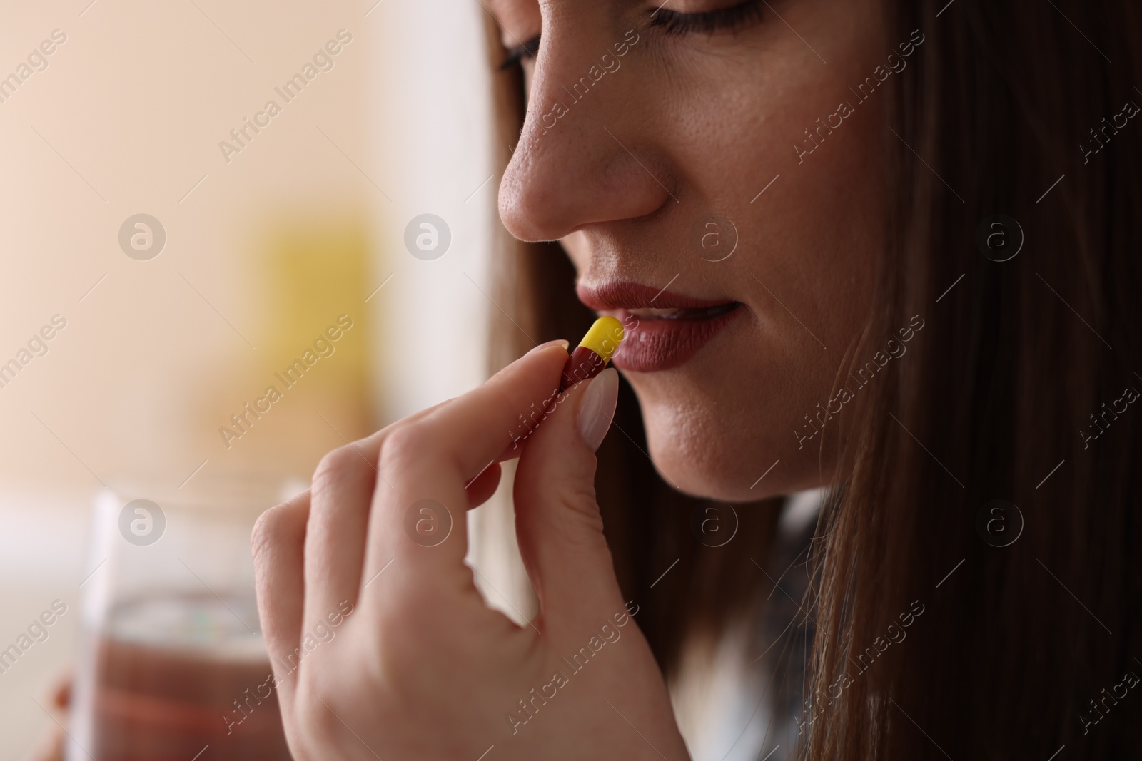 Photo of Woman taking medical pill at home, closeup