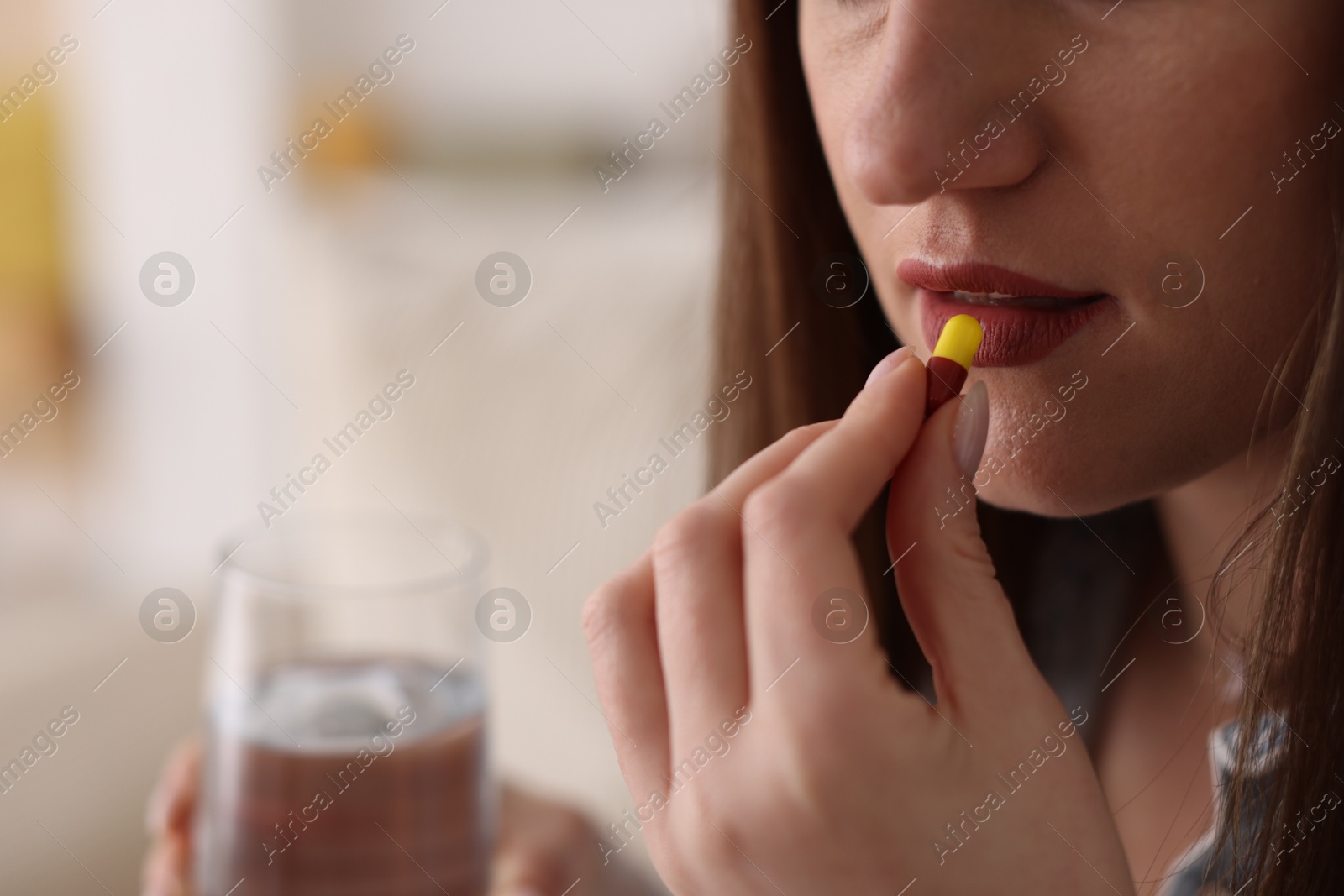 Photo of Woman taking medical pill at home, closeup