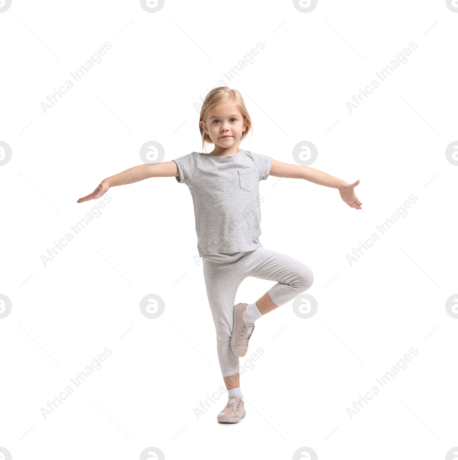 Photo of Little girl exercising on white background. Sport activity