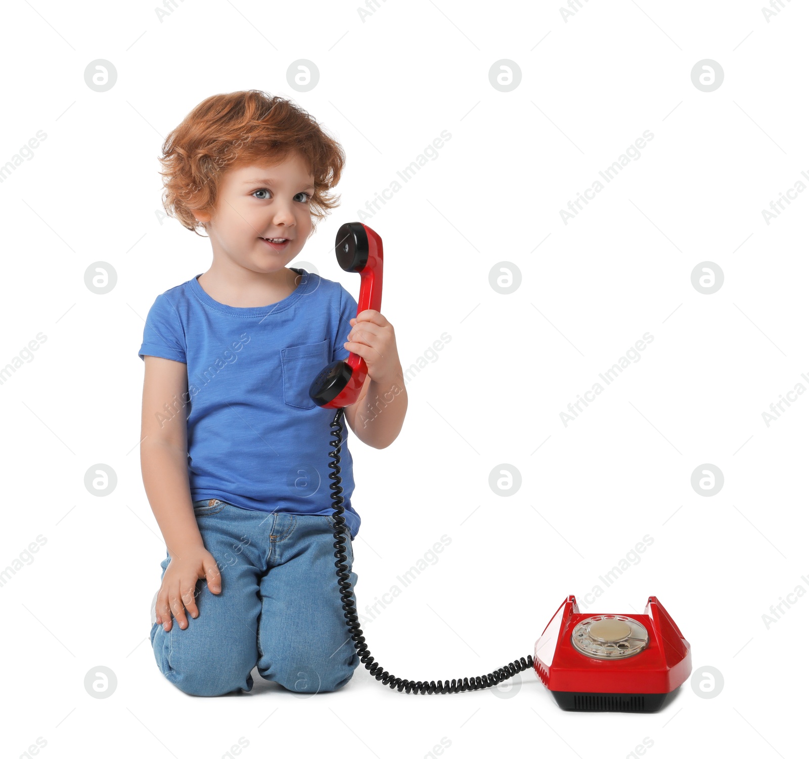 Photo of Cute little boy with telephone on white background