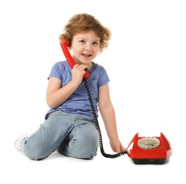 Photo of Cute little boy with telephone on white background