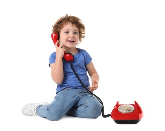 Photo of Cute little boy with telephone on white background