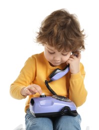 Photo of Cute little boy with telephone on white background