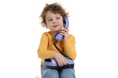 Photo of Cute little boy with telephone on white background