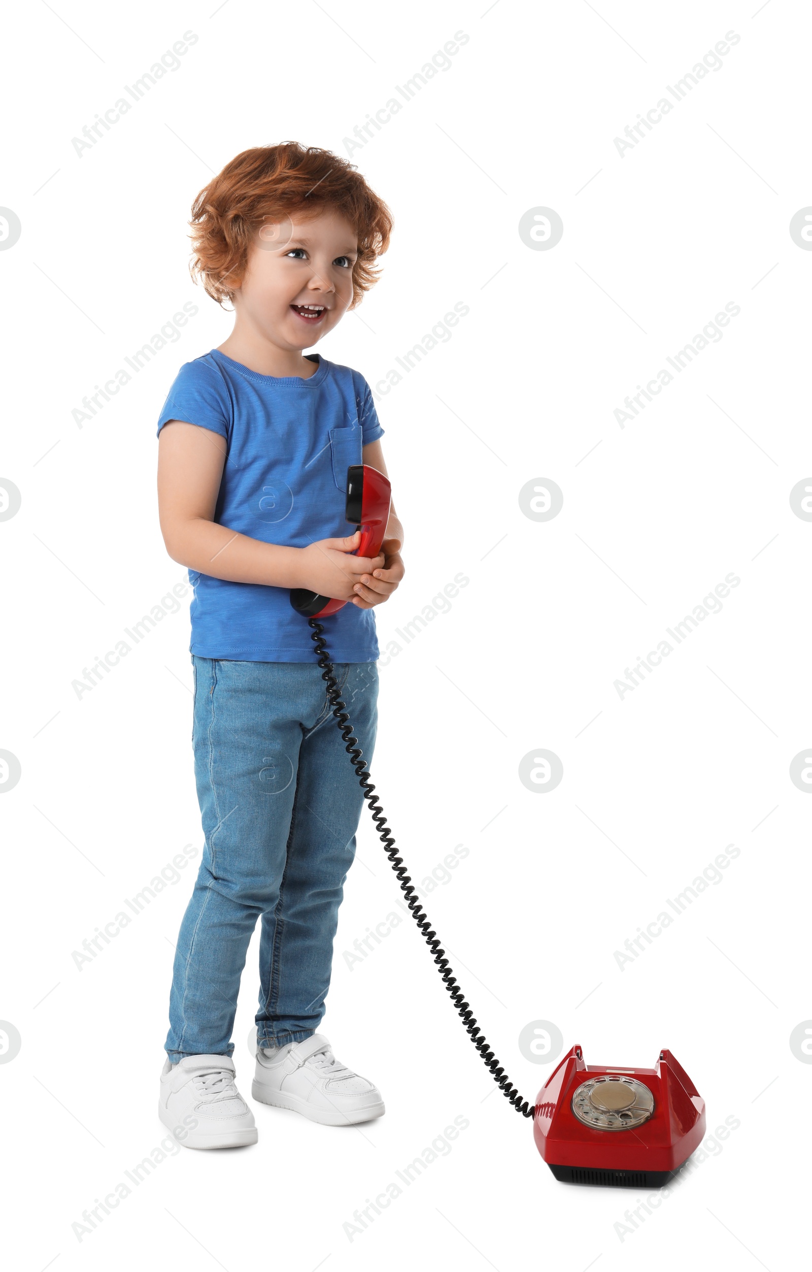 Photo of Cute little boy with telephone on white background