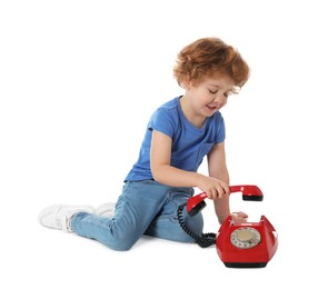 Photo of Cute little boy with telephone on white background