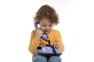 Photo of Cute little boy with telephone on white background