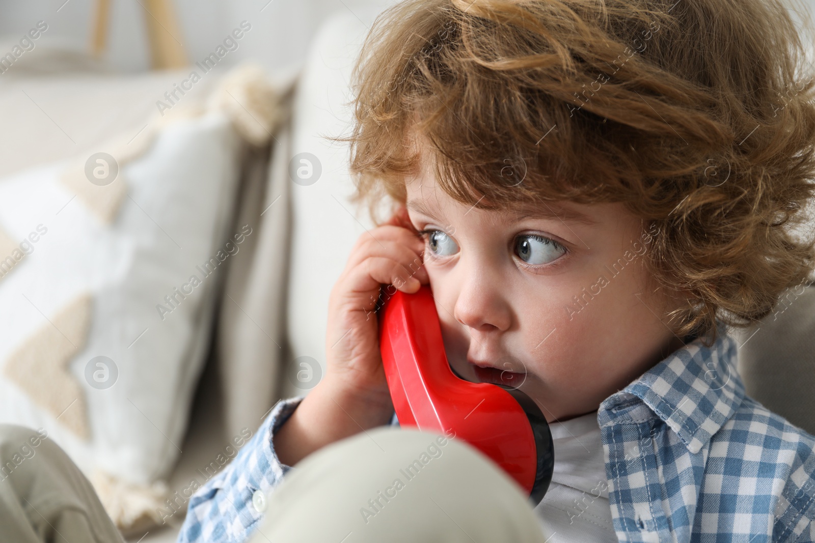 Photo of Cute little boy with telephone handset indoors, space for text