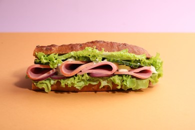 Photo of Baguette sandwich with ham on color background