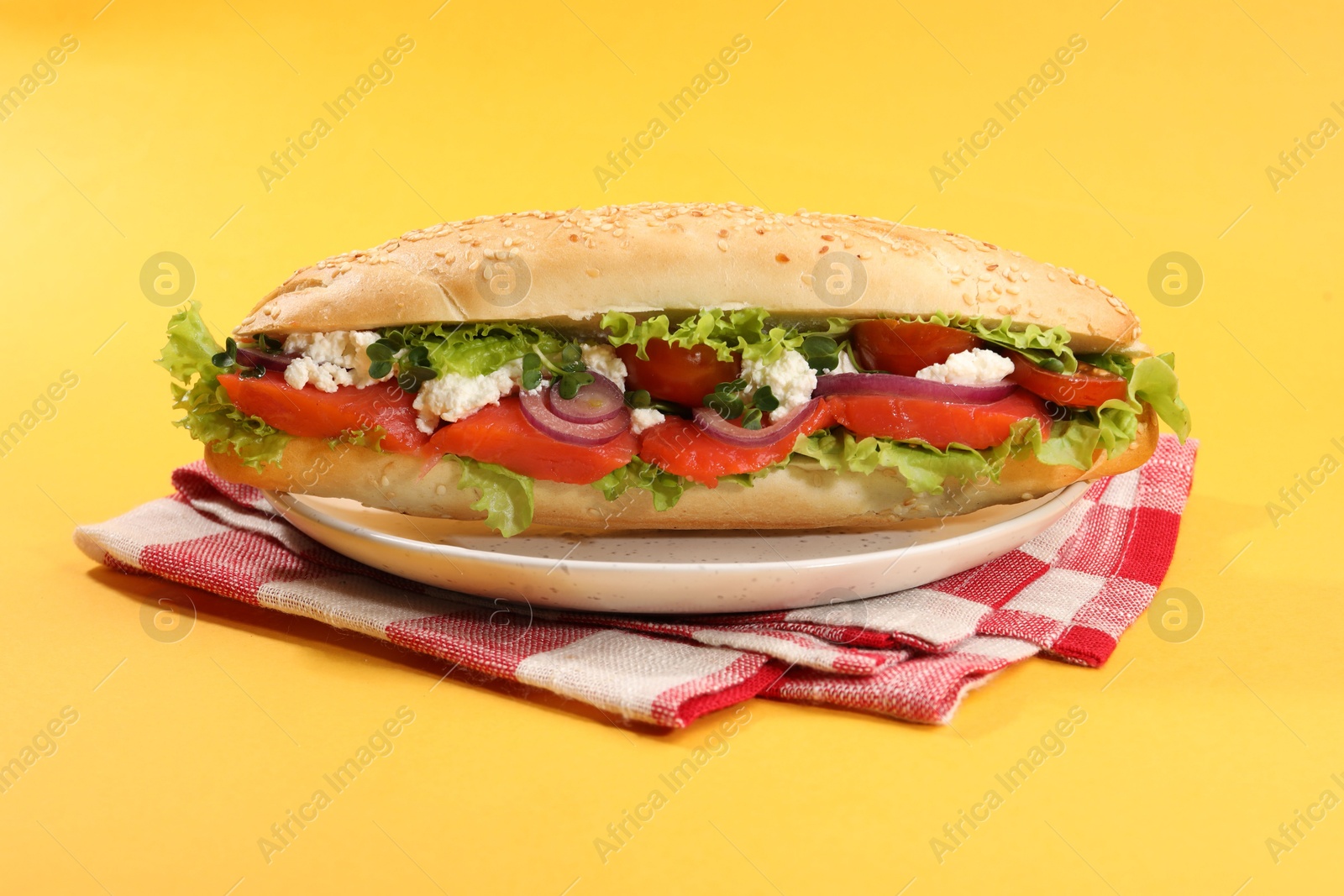 Photo of Delicious baguette with salmon on yellow background