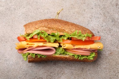 Photo of Delicious baguette sandwich on grey table, top view