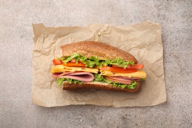 Photo of Delicious baguette sandwich on grey table, top view