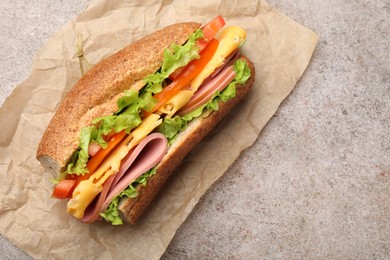 Photo of Delicious baguette sandwich on grey table, top view