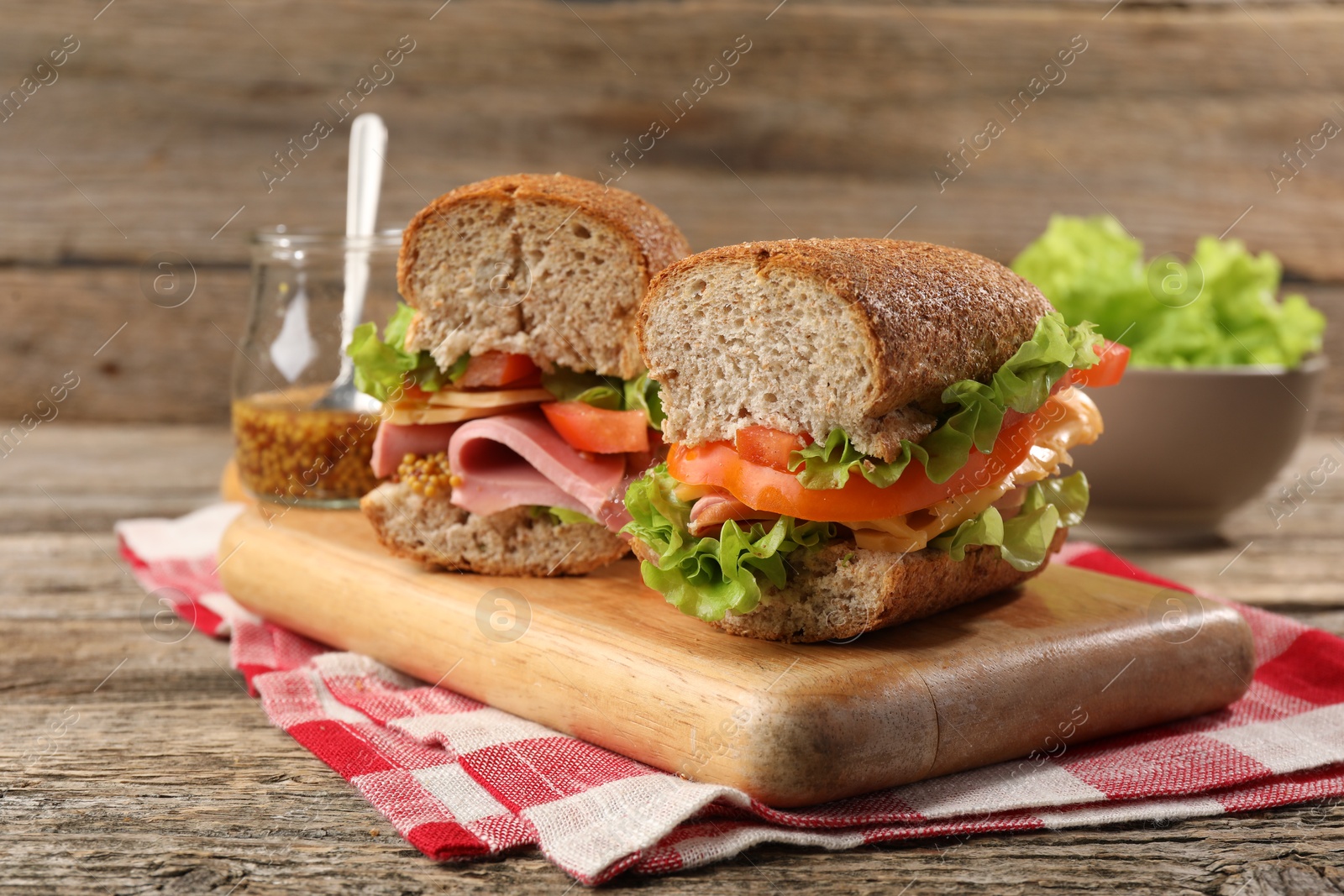 Photo of Delicious sandwiches with ham on wooden table, closeup