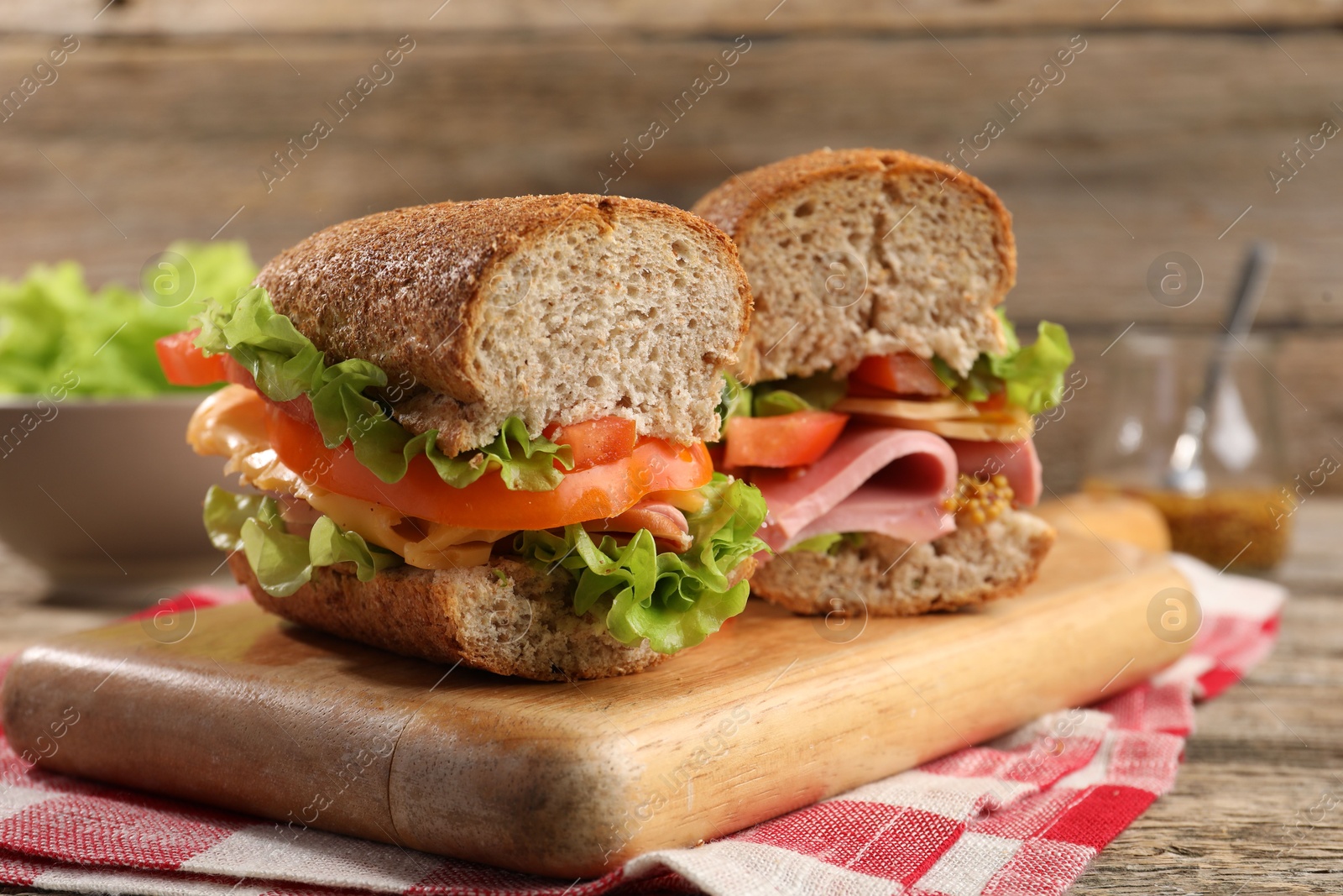 Photo of Delicious sandwiches with ham on wooden table, closeup