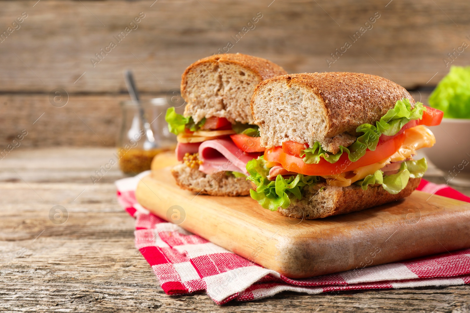 Photo of Delicious sandwiches with ham on wooden table, closeup