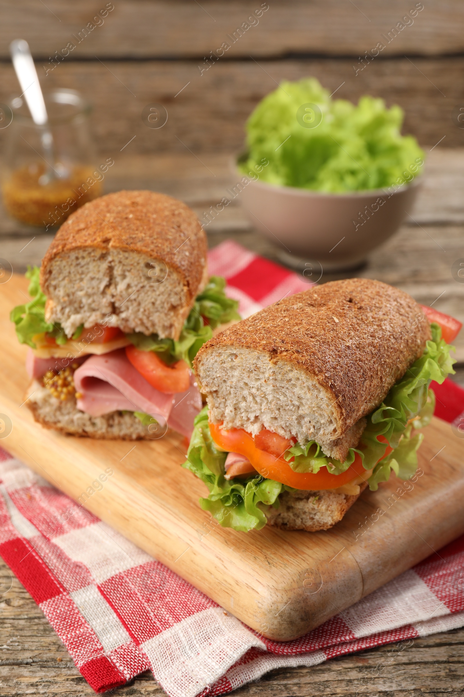 Photo of Delicious sandwiches with ham on wooden table, closeup