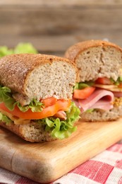 Photo of Delicious sandwiches with ham on wooden table, closeup