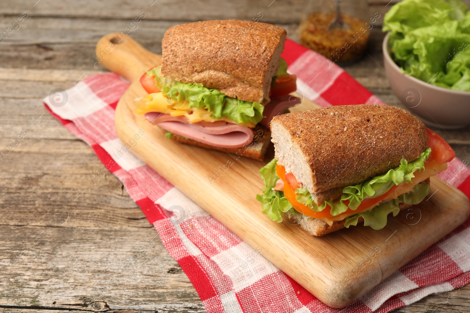 Photo of Delicious sandwiches with ham on wooden table, closeup