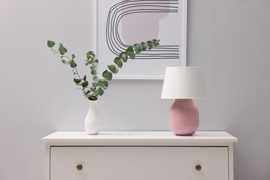 Photo of Console table with decor near white wall