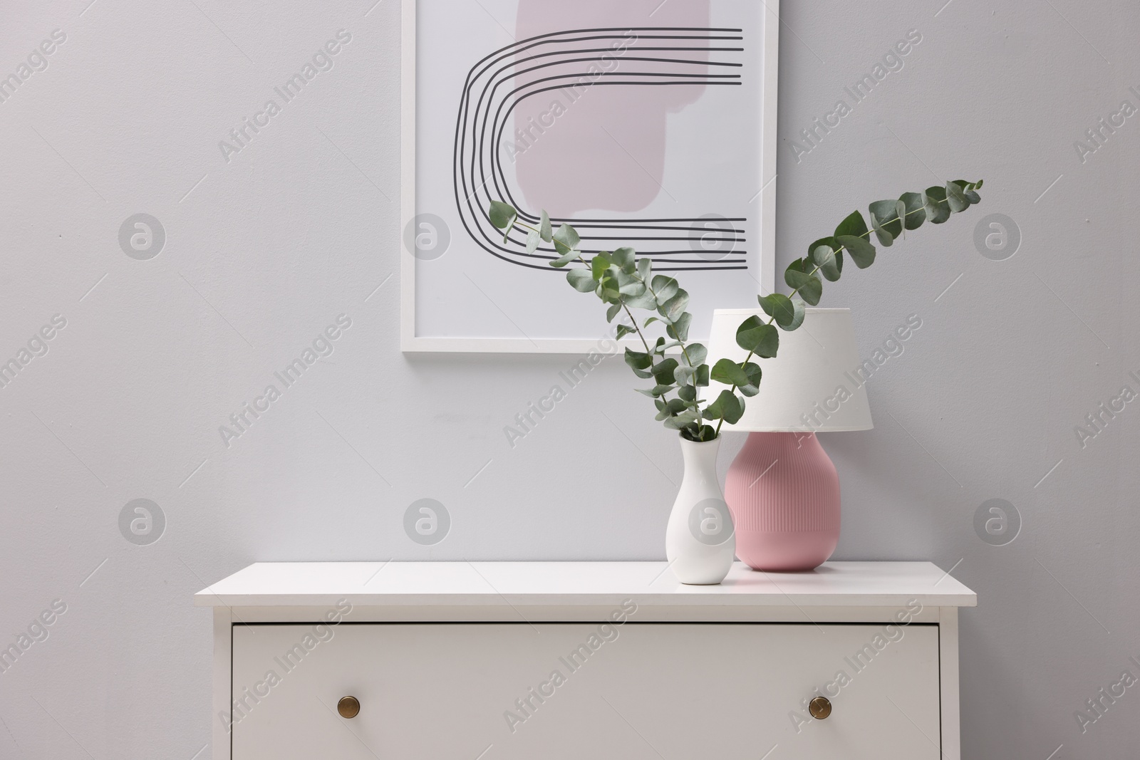 Photo of Console table with decor near white wall